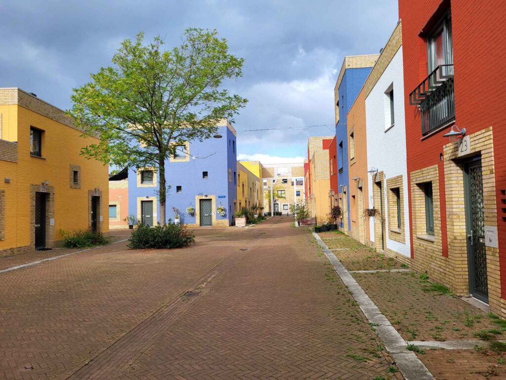 Eindhoven: Vom Philips-Erbe zur Zukunftsstadt 13 Autofreie Wohnstraße im Quartier VoltaGalvani mit gelben, blauen, weißen und roten Backsteinfassaden.