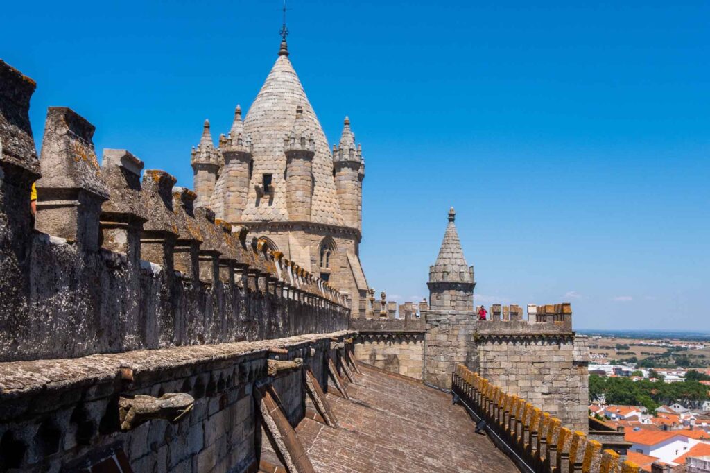 Évora 2027: Kulturhauptstadt im Alentejo setzt auf Reisen ohne Eile 3 Steinerne Türme und Dachterrasse der Kathedrale Sé de Évora vor blauem Himmel
